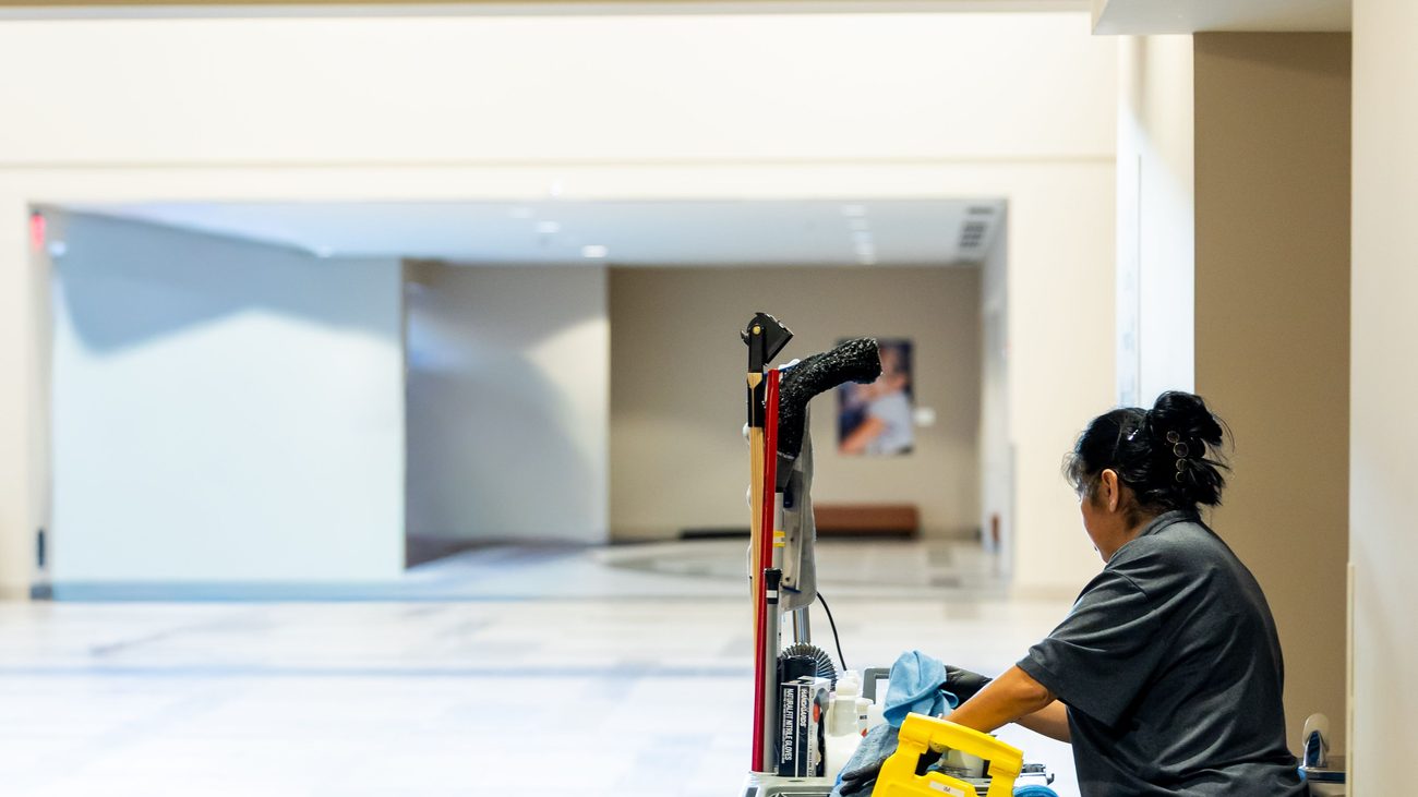 Cleaning team member with janitorial cart